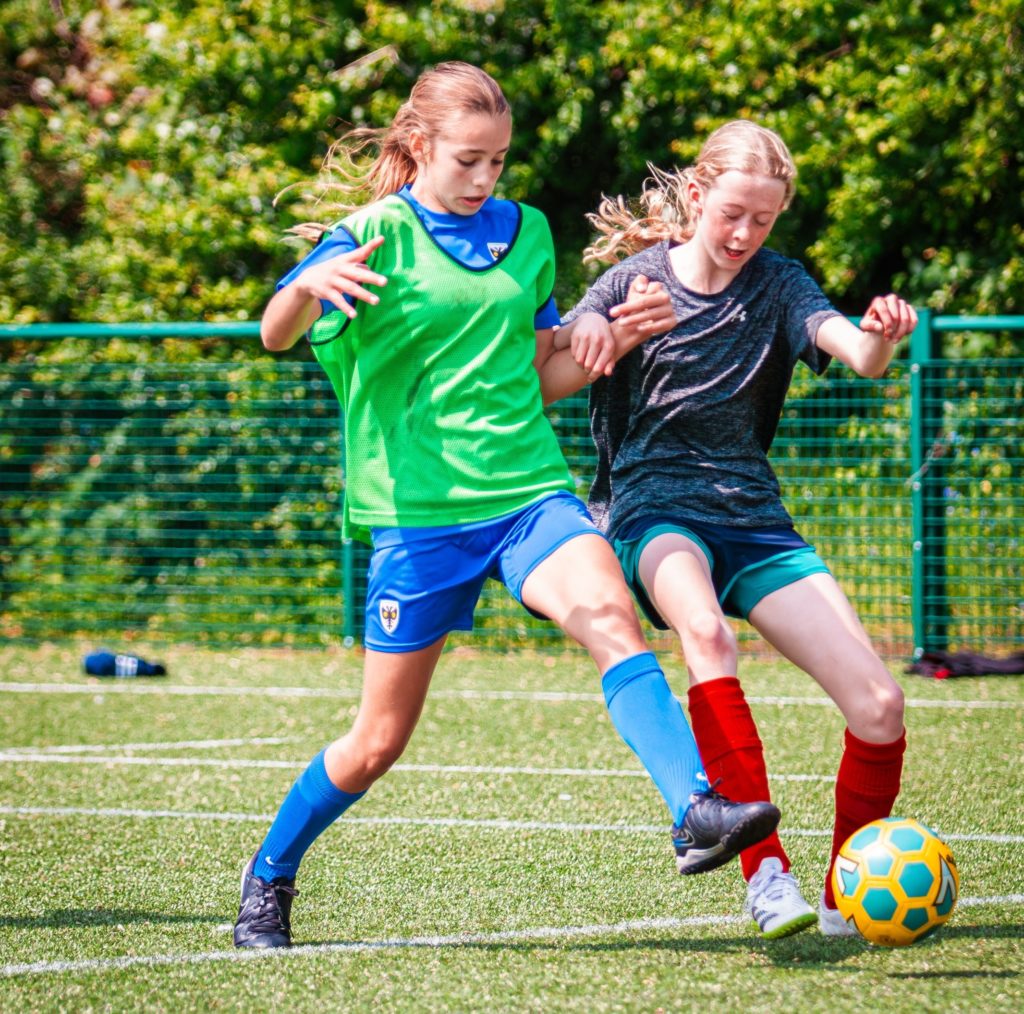 Girls playing football